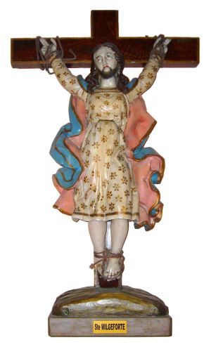 Kuvassa parrakas naispyhimys Wilgefortis ristiinnaulittuna mekko päällä.