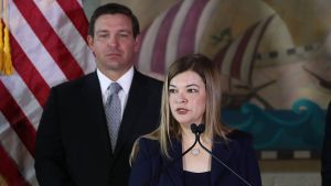 Barbara Lagoa håller tal efter att hon utnämns till Floridas högsta domstol. I bakgrunden delstatens guvernör Ron DeSantis. Domaren Barbara Lagoa i Florida. I bakgrunden Floridas guvernör Ron Desantis.