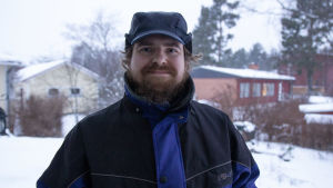 Martin skulle gärna uppleva järnåldern. En man står utomhus. Det är vinter med snö på marken.