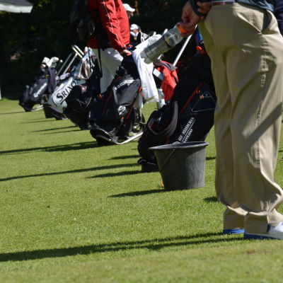 Golfare spelar golf i soligt väder.