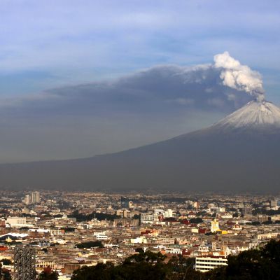 Jatkuvasti purkautuva Popocatépetl-tulivuori kohoaa Pueblan kaupugin ylle Meksikossa.