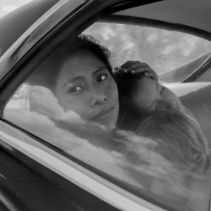 Yalitza Aparicio istuu auton takapenkillä. Kuva elokuvasta Roma (2018).
