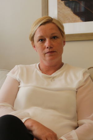 Oikeuspsykologian dosentti Helinä Häkkänen-Nyholm on tutkinut vieraannuttamista huoltajuusriidoissa. Nainen istumassa sohvalla.