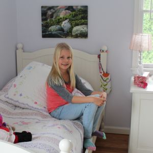 Lia Hartwall har hittat nya fritidsintressen i USA. Hon dansar, spelar piano och är med i skolans cupcake-dekorationsklubb. Lia Hartwall sitter på sängen i sitt rum i USA