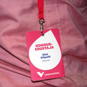 Eliel Kilpelä tycker att det är bra att samlas till partikongressen för att vidga perspektivet. Verkligheten ser olika ut på olika håll i landet. Eliel Kilpeläs namnskylt på partimötet i Kuopio.