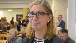 Elina Antila, vd för Borgå vatten. porträtt på elina antila i ett rum fullt med folk