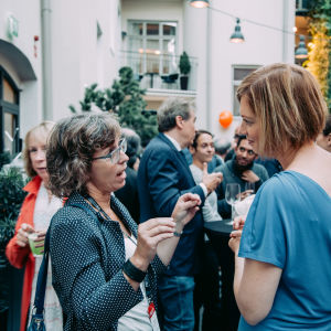 Two woman talking during a mingle.