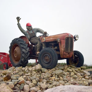Traktor parkerad på stenhög