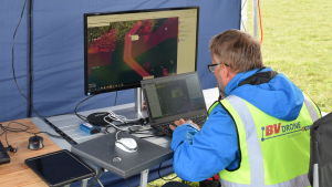 Drönarens färd genom luften kunde noggrant följas med genom en monitor på marken. Man som följer med drönarflygning på monitor.