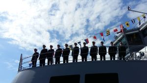 Marinofficerare står på kommandobryggan till ett av marinens örlogsfartyg.