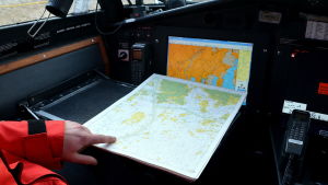 Inget kartplotter kan ersätta förmågan att navigera efter sjökort om man hamnar i nöd. Sjökort framme i förarhytt.