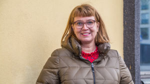 Mikaela Nylander ser fram emot att få arbeta med kultur och utbildning på svenska. Leende kvinna står framför gul vägg