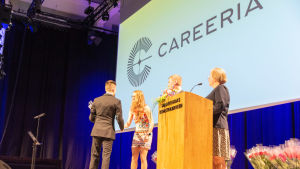 Careerias nya logo syntes stort under festen. Utexaminering på gång i festsal.