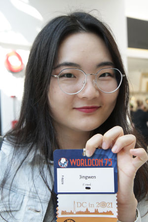 Woman holding a name tag.