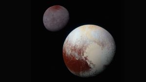 Pluto med månen Charon. Dvärgplaneten Plutå med månen Charon.