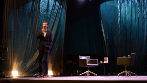 Skådespelaren Pekka Strang fungerade som festivalvärd. En man står på en scen och pratar i mikrofon