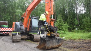 Jarmo Hynynen gör i ordning grävmaskinen som används för att täcka in diket där jordkablarna finns. Jarmo Hynynen servar grävskopan innan han ska gräva ner jordkablar.