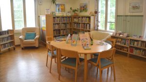 Staden hoppas att fler ska lockas till bibloteken. På bilden Karislojo bibliotek. Stolar och bord i en bibliotekssal.