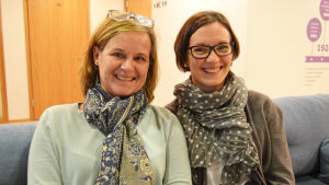 Nina Hongell-Ekholm och Petra Turja drar mamma- och föräldrakurser på Folkhälsan. Nina Hongell-Ekholm och Petra Turja sitter i en soffa på Folkhälsan