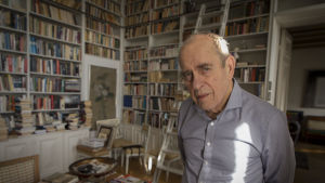 Jörn Donners far Kai Donner var kusin till Ruth Munck. Enligt Jörn Donner var Ruth Munck en charmant person – även om hon var mycket tyskvänlig och högersinnad. Värikuva. Donner seisoo ja katsoo kameraan. Taustalla kirjahyllyjä. Helsinki, Pohjoisranta. 20.3.2017
