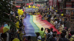 Prideparader för sexuellt likaberättigande har uppnått närapå mainstreamstatus i många metropoler så som Hongkong på bilden, medan Prideparader förbjudits på andra ställen som i Moskva, som år 2012 införde ett hundraårigt prideparadförbud. Prideparad i Hongkong år 2015. Folkmassan håller upp en jättelik regnbågsflagga. Överallt syns gula ballonger.