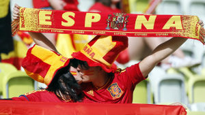 Espanjalaiset jalkapallofanit suutelevat katsomossa.