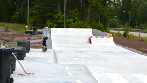 Akseli Vuorenjuuri har väntat på att få en skejtpark till Lappträsk. Pojke åker rullbräda med händerna i luften i skejtpark