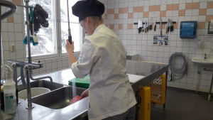 Det är inte bara gymnasieböcker som blir dyra. Kockkläder, knivar och andra redskap kostar också. Arkivbild. Elev i Inveon diskar.