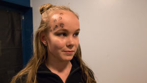 Lotta Puustinen har panterfläckar i pannan – på isen gestaltar hon flera olika djungeldjur. bild på en flicka