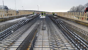 I höst ska bilar kunna köra här på den nya järnvägsbron i Karis. Arbetare på järnvägsbron i Karis. De jobbar med armeringsarbeten.