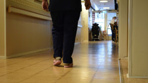 Personalen vid Almahemmet är väldigt trötta på det osäkra läget. Två ben som går bortåt i en korridor i Almahemmet.