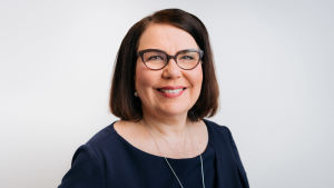 Merja Ylä-Anttila looks into the camera and smiles in a profile picture.