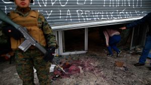 En soldat övervakar ett vandaliserat köpcenter i Santiago. Åtminstone 40 köpcenter och andra företag plundrades på söndagen, enligt det chilenska inrikesministeriet. En soldat övervakar ett vandaliserat köpcenter i Santiago. Åtminstone 40 köpcenter och andra företag plundrades på söndagen, enligt det chilenska inrikesministeriet.