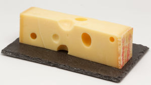 Emmentaler är fortfarande en av vårt lands mest populära vardagsostar. En bit emmentalerost på en träbricka