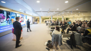 Kring hundra personer deltog i Helsingfors öppna föräldramöte. Ett seminarie av något slag. En kvinna föreläser för kring 100 personer.