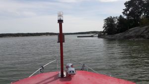 Lokala pärlor: Med båt på Erstan, strax utanför Åbo. Båttak och hav, en holme och en brygga