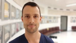 Enligt Aaro Turunen var de allra flesta patienterna berusade då olyckan inträffade. Aaro Turunen, en man med mörkt hår, skäggstubb och blå skjorta, står vid en vägg med färggranna tavlor.