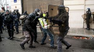 Polisen griper en demonstrant på Champs Élysées på lördag eftermiddag då hundratals andra redan gripits. Polisen griper en demonstrant på Champs Élysées på lördag eftermiddag då hundratals andra redan gripits.