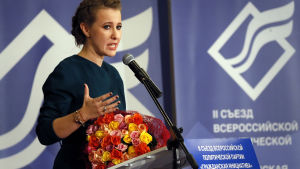 Zjirinovskij har lyckats provocera motkandidaten Ksenija Sobtjak att hälla ett glas vatten över honom. Ksenia Sobtjak talar på konferens i december 2017.