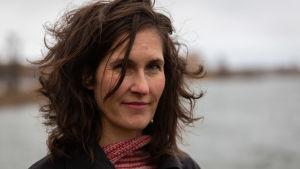 Malin Kivelä har fått Svenska Yles litteraturpris för sin roman Hjärtat, samma bok som gav henne platsen som en av kandidaterna till Runebergspriset.. Kirjailija Malin Kivelä seisoo ulkona. Taustalla meri.