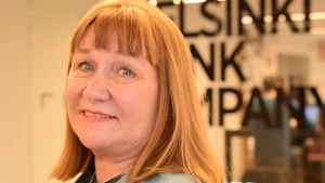Prorektor Hanna Snellman säger att universitetsledningen inte har fått några officiella bevis på att övertramp skulle ha gjorts vid Konfuciusinstitutet. Hanna Snellman i grå tröja, småler mot kameran, interiör från universitetets Think corner i bakgrunden