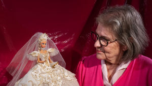 Barbie-keräilijä Ursula Kähärä morsiuspukuinen Barbie kädessään.