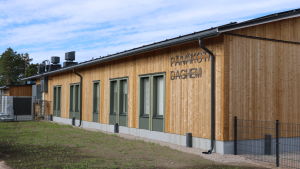 Nu har dagisbarnen fina nya utrymmen. En träbyggnad. Texten päiväkoti daghem syns tydligt på fasaden.