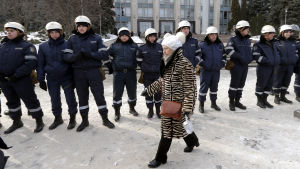 En kvinna passerar kravallpoliser i Chișinău söndagen den 24 januari Kvinna passerar kravallpolis i Moldaviens huvudstad Chișinău 24 januari 2016