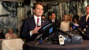 Anthony Scaramucci inför utrikesjournalisterna i New York. Anthony Scaramucci talar tll journalister med ett snett leende.