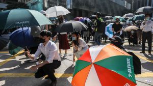 Kontorsarbetare och demokratiaktivister skyddade sig från polisen med paraplyer i centrala Hongkong. Personer som skyddar sig från tårgas med paraplyer i Hongkong.
