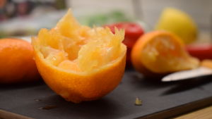 Passa på att köpa citrusfrukter när de är i säsong. En mandarinhalva på en skärbräda.