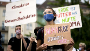 Klimatdemonstrationerna har på sommaren tagit på sig en mask och återigen blivit fysisk, efter några månaders digitala demonstrationer. Bild från Berlin den 26 juni. Människor med plakat i händerna.