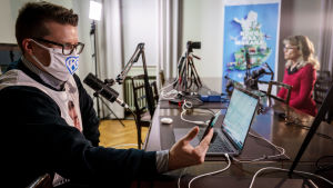 Kristdemokraternas Asmo Maanselkä intervjuar partiordförande Päivi Räsänen under ett virtuellt valevenemang. Päivi Räsänen Kristillisdemnokraattien striimaustudiossa. Etualalla puoluesihteeri Asmo Maanselkä fasilitoimassa lähetystä.