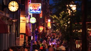 I normala fall är gatorna i De Wallen knökfulla. Men nu är det tyst om kvällen. Nattlig bild med folkmassor som vandrar längs sexstråket i Amsterdam